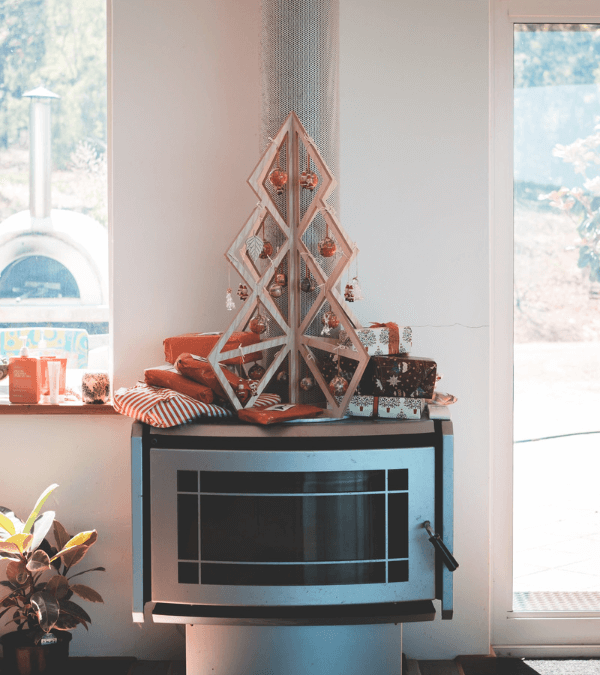 A DIY wooden mini Christmas tree decorated with Christmas balls