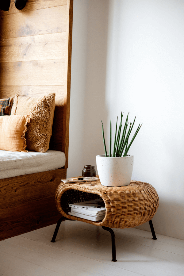 a rattan magazine skirt side table