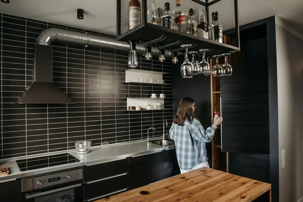 A woman looking in the cupboard in an industrial kitchen