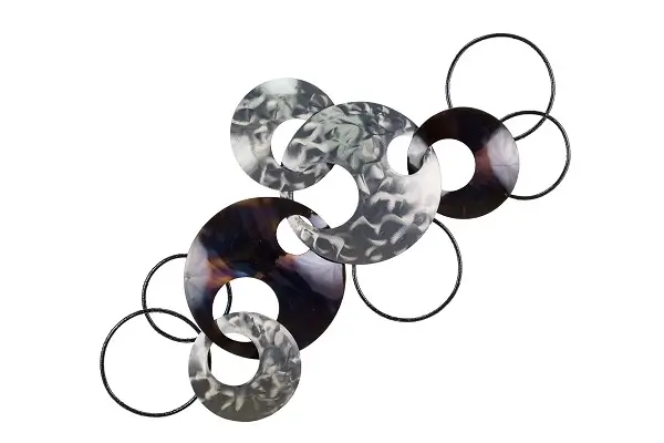A metal wall sculpture with round rings in colors dark brown and silver