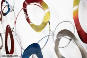 Close-up of interconnected abstract metal loops in vibrant colors.