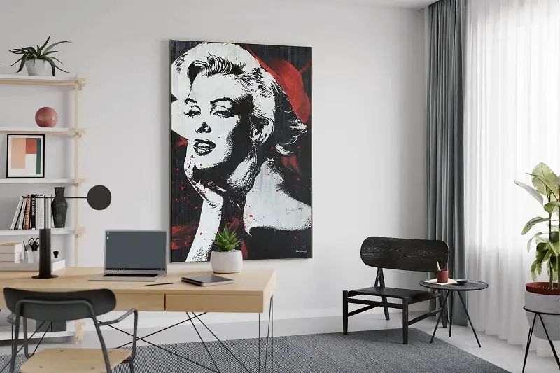 An office room with a large wall painting of Marilyn Monroe