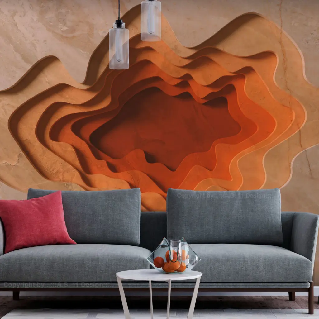 A 3D-effect wall art piece with layered, topographical cutouts in warm orange and terracotta tones, situated behind a grey contemporary sofa.