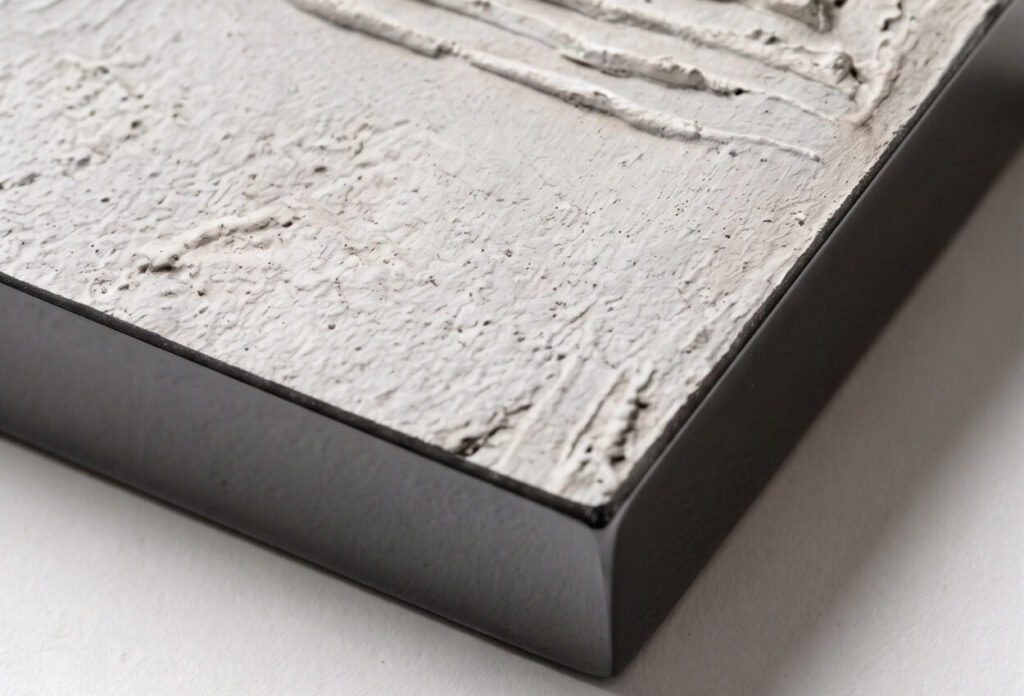 Close-up of textured abstract artwork with a slim black frame.